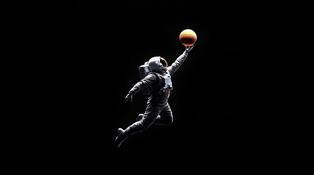 Astronaut holding a basketball in space